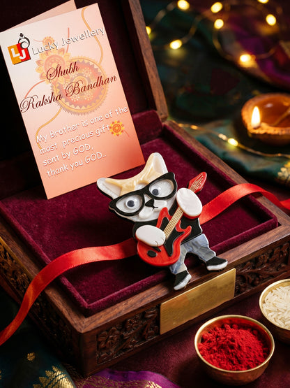 Kids Rakhi: Cute Rockstar Cat Playing Guitar Acrylic Charm on Red Ribbon, Roli, Chawal & Card (440-CHR1-1192-1-2026)