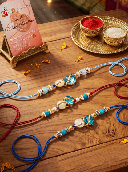 Designer Rakhi Set of 3: Blue Crystal, Cream Stone, Metallic Spacers, Roli, Chawal & Card (300-CHR1-1002A-3-2026)