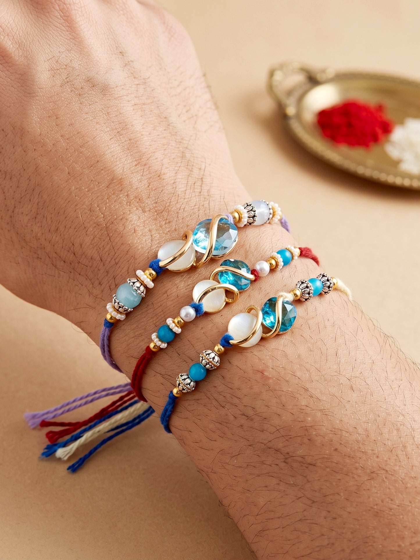 Designer Rakhi Set of 3: Blue Crystal, Cream Stone, Metallic Spacers, Roli, Chawal & Card (300-CHR1-1002A-3-2026)