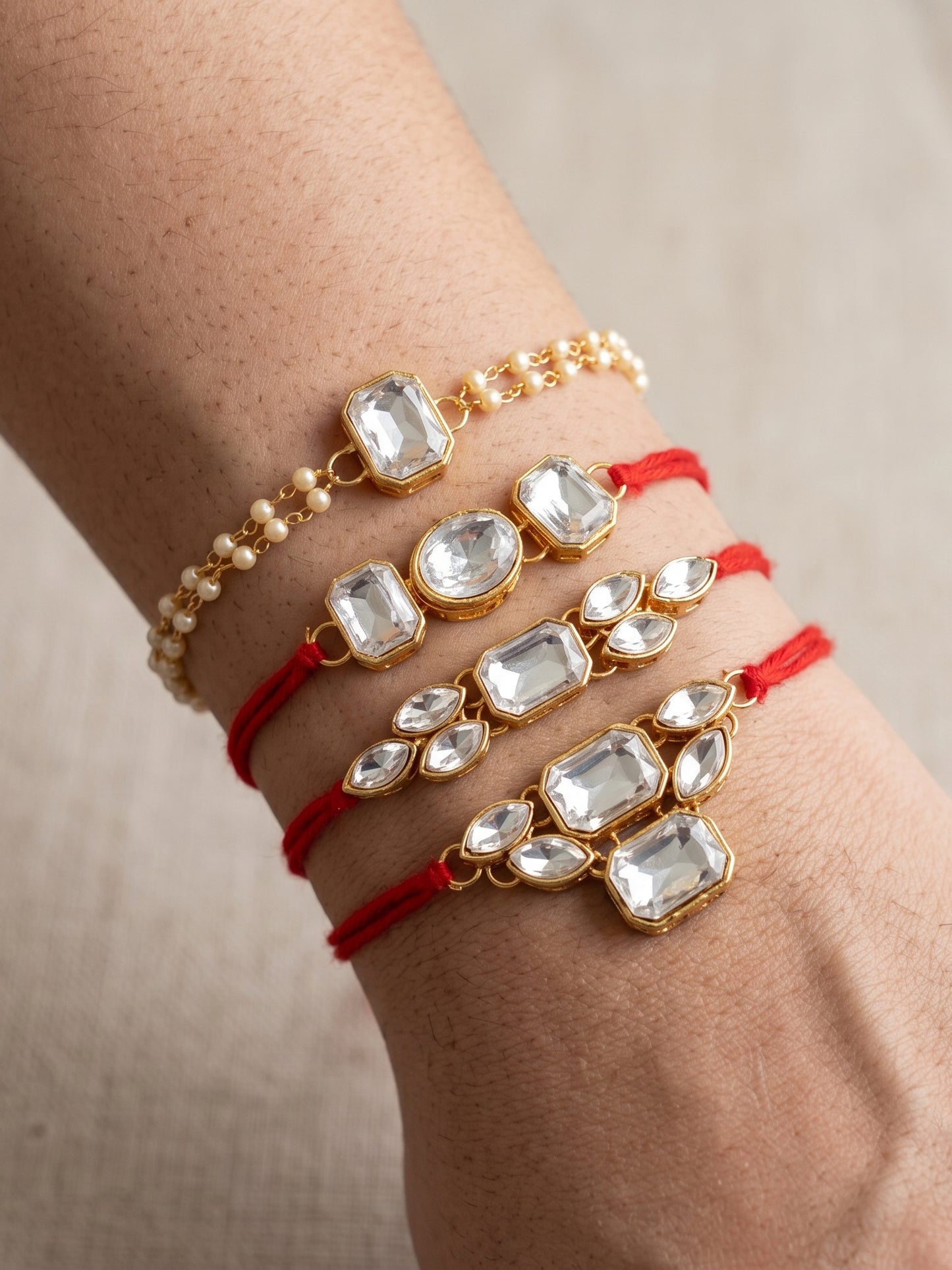 LUCKY JEWELLERY Traditional Rakhi for Brother/Bhaiya – Gold Plated Red Thread Rakshabandhan Rakhie White Stones for Bhai/Bhabhi (Pack of 4) – Fancy Rakhee Bracelet Rakshasutra (182-L1R1-18-W-4-2026)