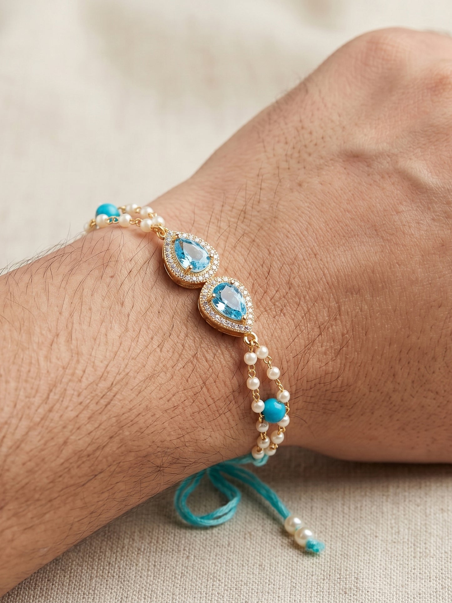 Adjustable Rakhi Bracelet with Blue drop AD Pendant, Turquoise & White Beads on Double Chain (200-CHB2-1279-F-2026)