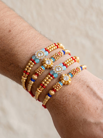 Lucky Jewellery Set of 4 Rakhi with Small Crystal Floral Centerpieces, Gold-Tone Beads, Roli Chawal & Card (58-S7R1-2314-4)