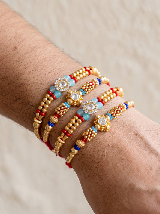 Lucky Jewellery Set of 4 Rakhi with Small Crystal Floral Centerpieces, Gold-Tone Beads, Roli Chawal & Card (58-S7R1-2314-4)