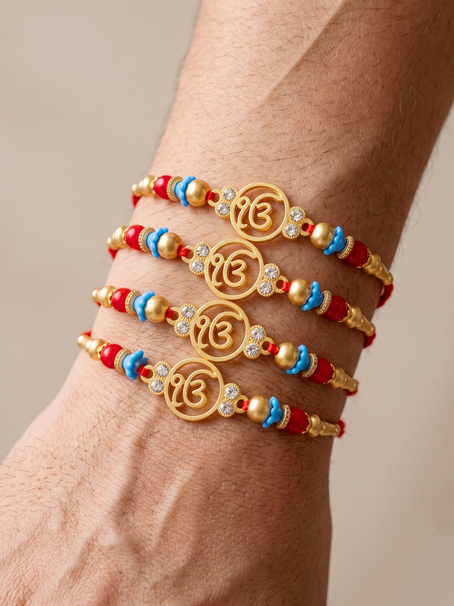 Lucky Jewellery Set of 4 Rakhi with Ek Onkar Pendant, Maroon & Blue Beads, Roli Chawal & Card (62-S7R1-2322-4)
