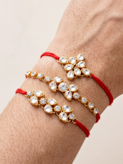 LUCKY JEWELLERY Traditional Rakhi for Brother/Bhaiya – Gold Plated Red Thread Rakshabandhan Rakhie White Stones for Bhai/Bhabhi (Pack of 3) – Fancy Rakhee Bracelet Rakshasutra (159-L1R1-09-W-3-2026)