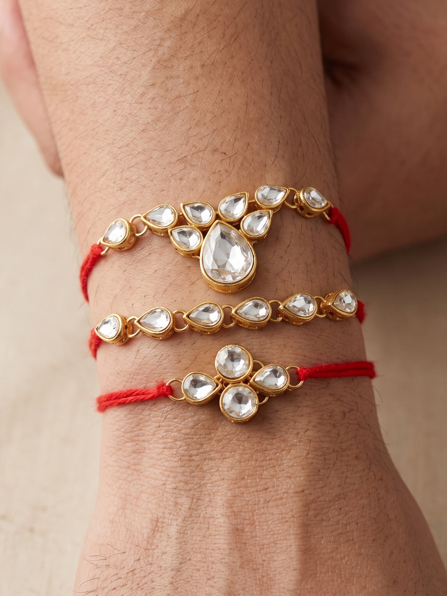 LUCKY JEWELLERY Traditional Rakhi for Brother/Bhaiya – Gold Plated Red Thread Rakshabandhan Rakhie White Stones for Bhai/Bhabhi (Pack of 3) – Fancy Rakhee Bracelet Rakshasutra (159-L1R1-04-W-3-2026)