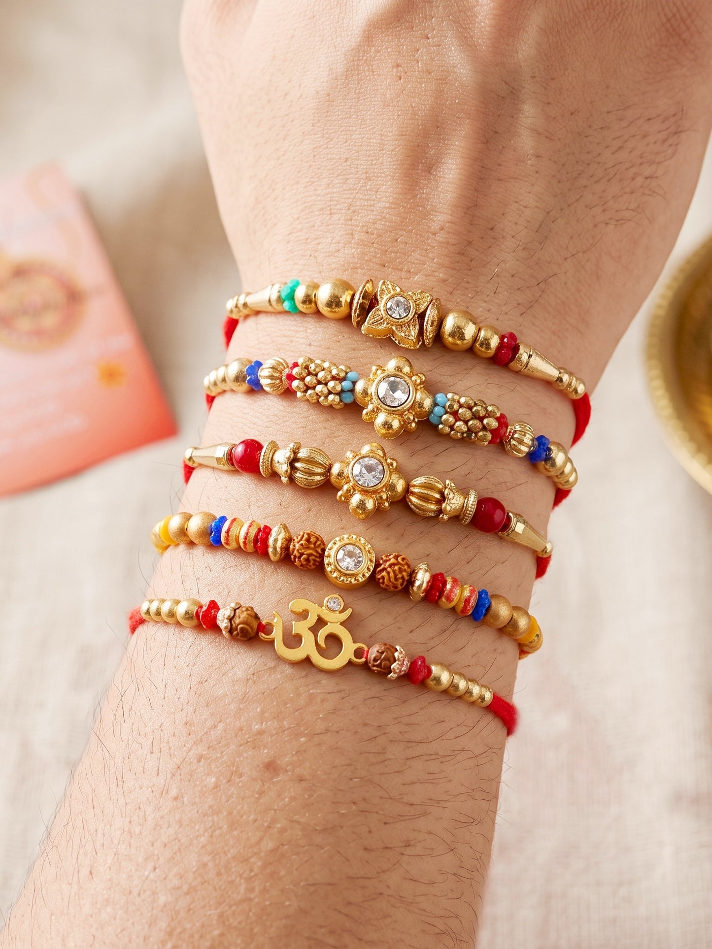 Lucky Jewellery Set of 5 Rakhi with Small Floral & Om Centerpieces, Gold-Tone Beads, Roli Chawal & Card (57-S7R1-2313-5)