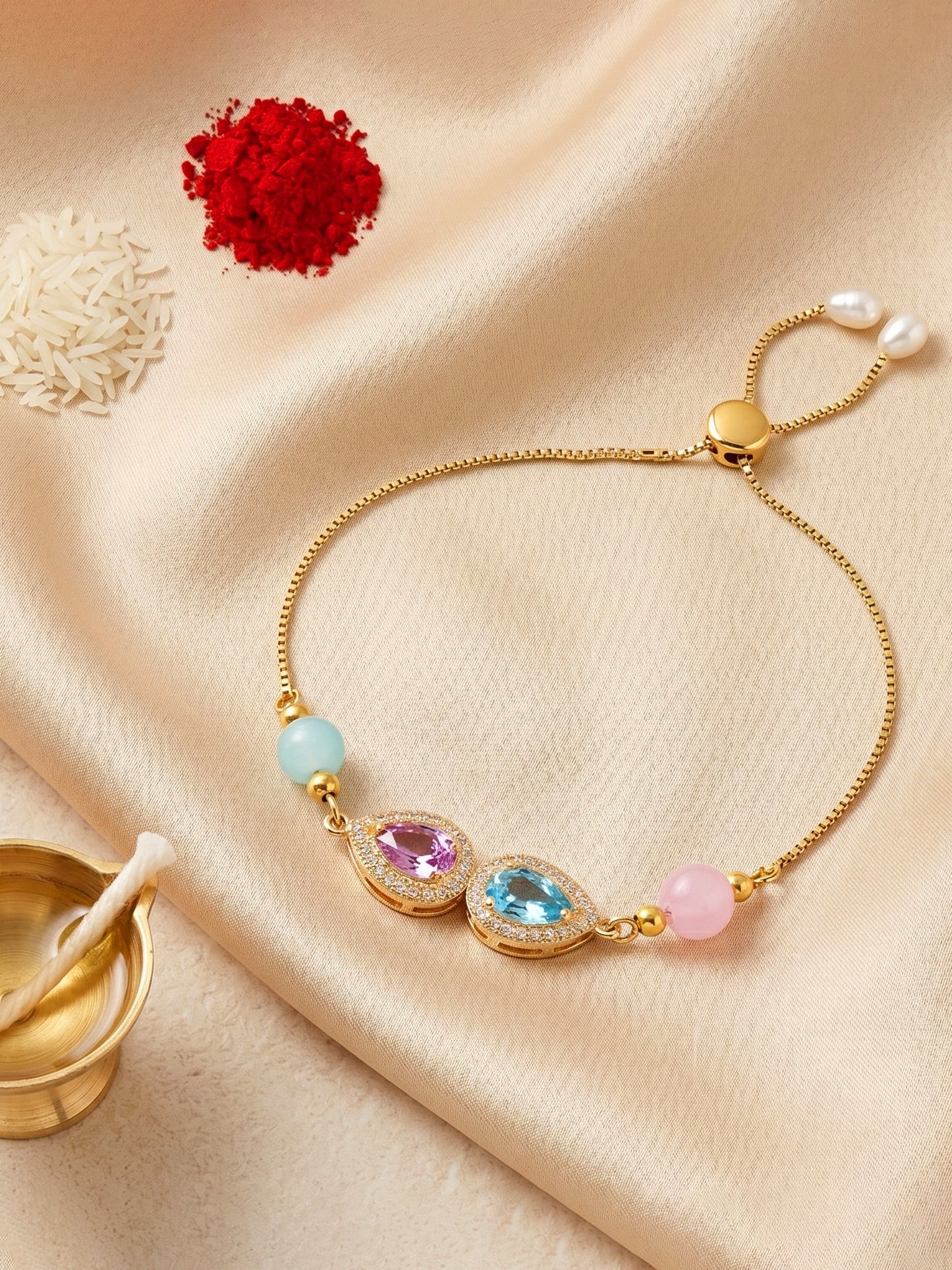 Adjustable Rakhi Bracelet with Blue & Pink drop AD Pendant,Pastel Beads,Roli Chawal & Card (209-CHB2-1279-PKF-2026)