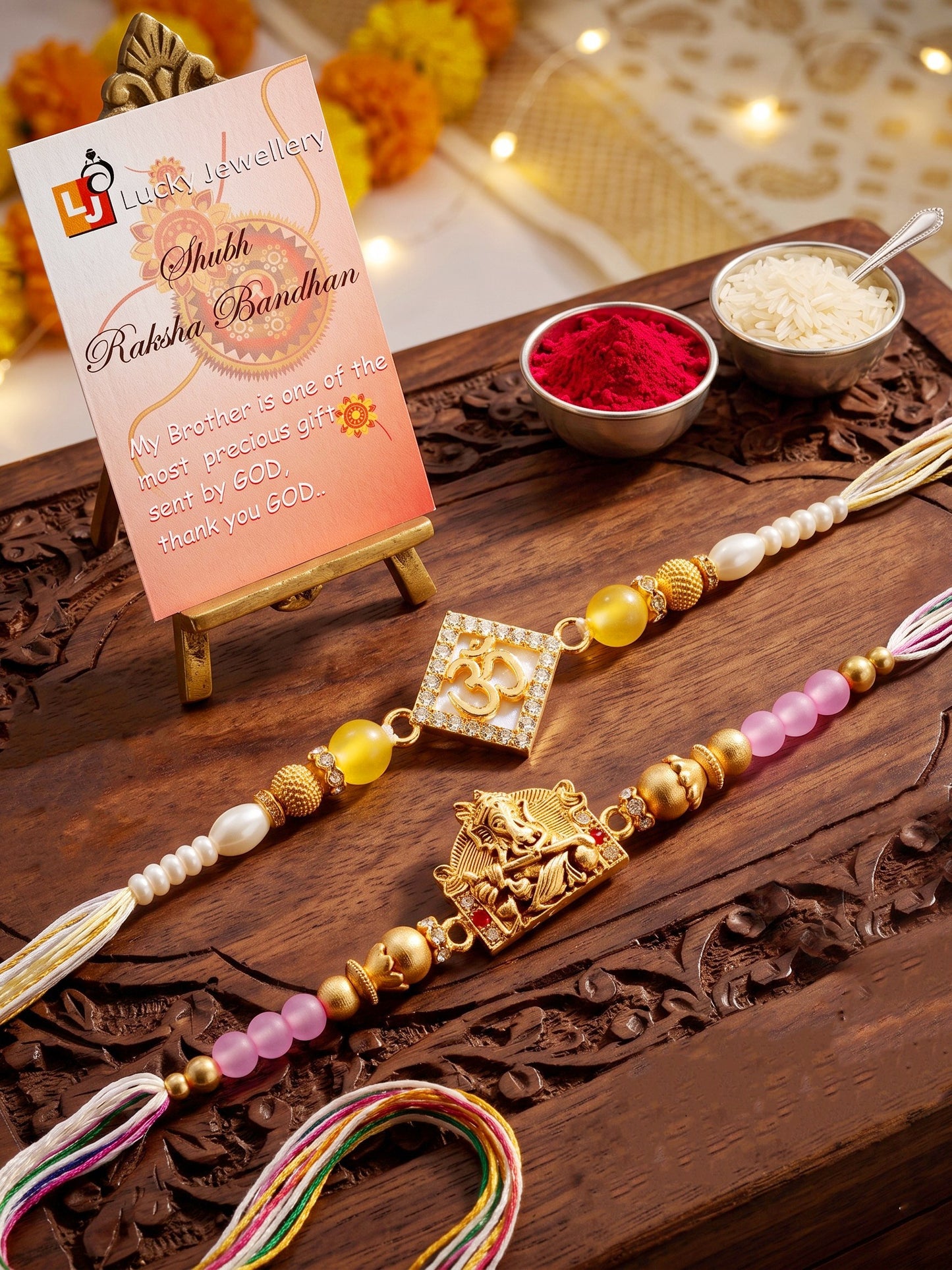 Lucky Jewellery Set of 2 Rakhi with Om & Ganesha Pendants, Pink & Smooth White Beads, Roli Chawal & Card (188-S7R1-2316-2)