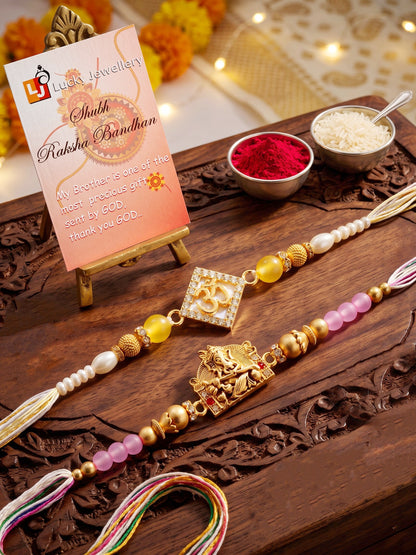 Lucky Jewellery Set of 2 Rakhi with Om & Ganesha Pendants, Pink & Smooth White Beads, Roli Chawal & Card (188-S7R1-2316-2)