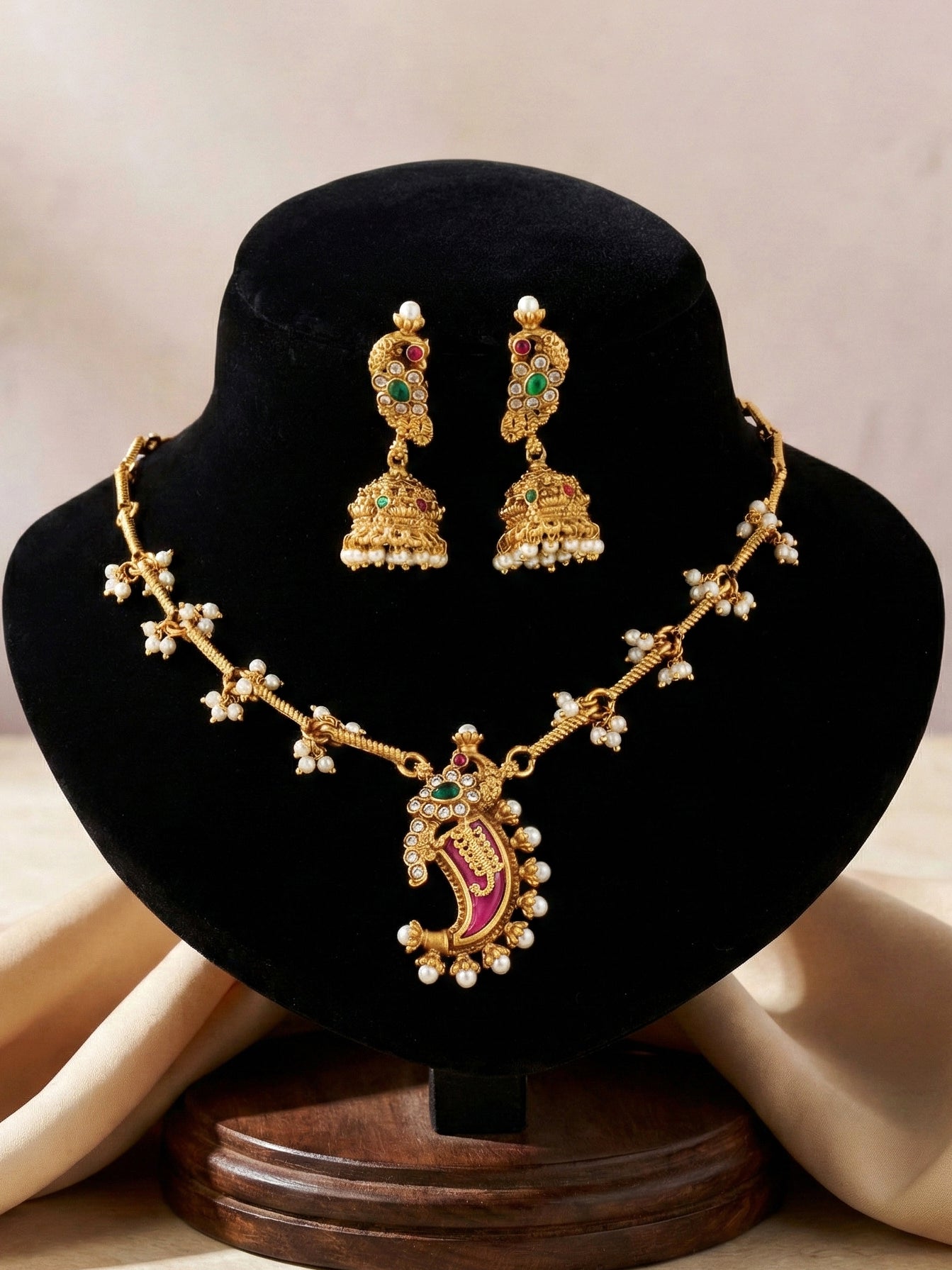 Traditional Gold-Tone Paisley Pendant Necklace Set with Dome Jhumka Earrings | Pink Enamel Meenakari Detailing & Green Stone Embellishments (689-ISR-2182-RG)