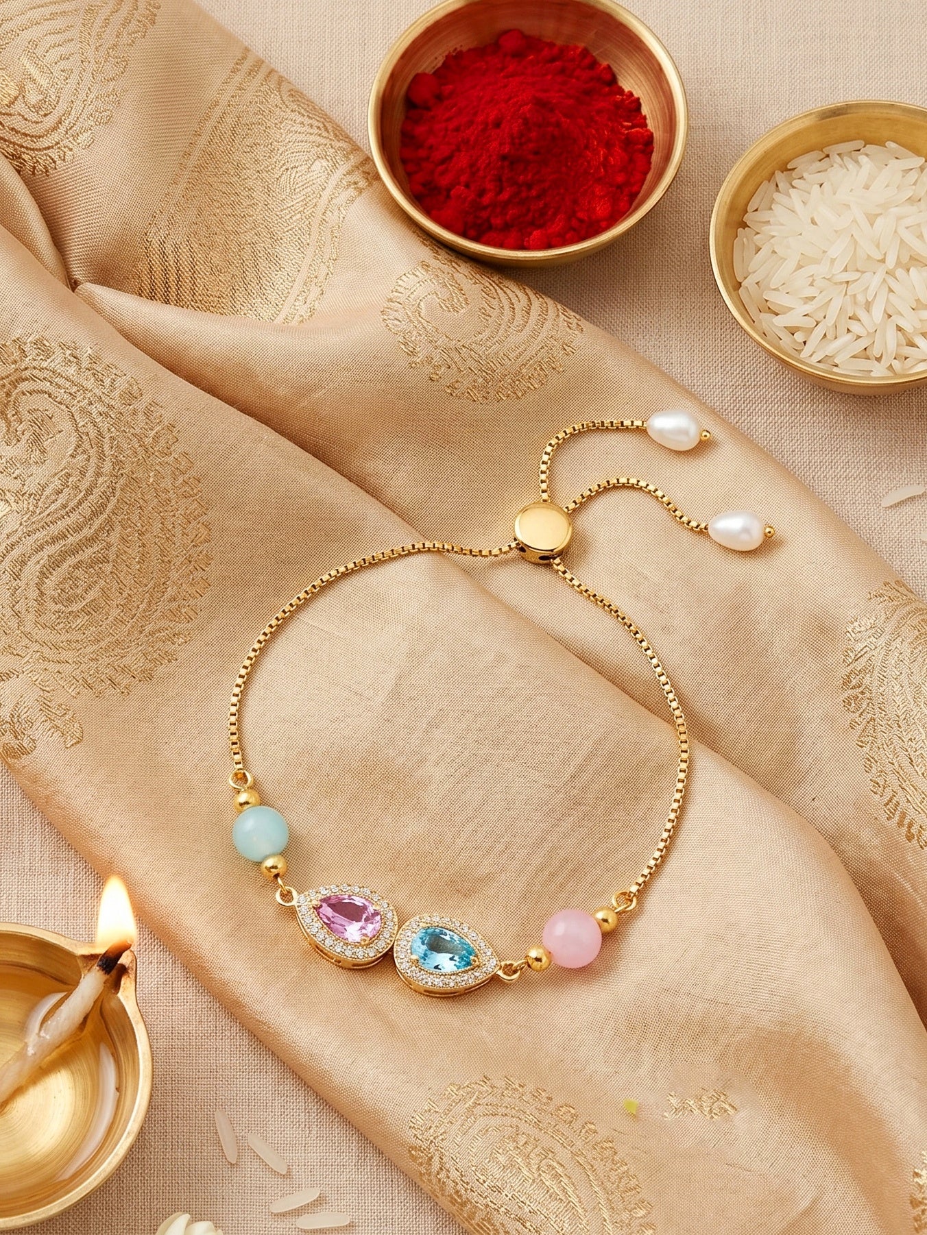 Adjustable Rakhi Bracelet with Blue & Pink drop AD Pendant,Pastel Beads,Roli Chawal & Card (209-CHB2-1279-PKF-2026)