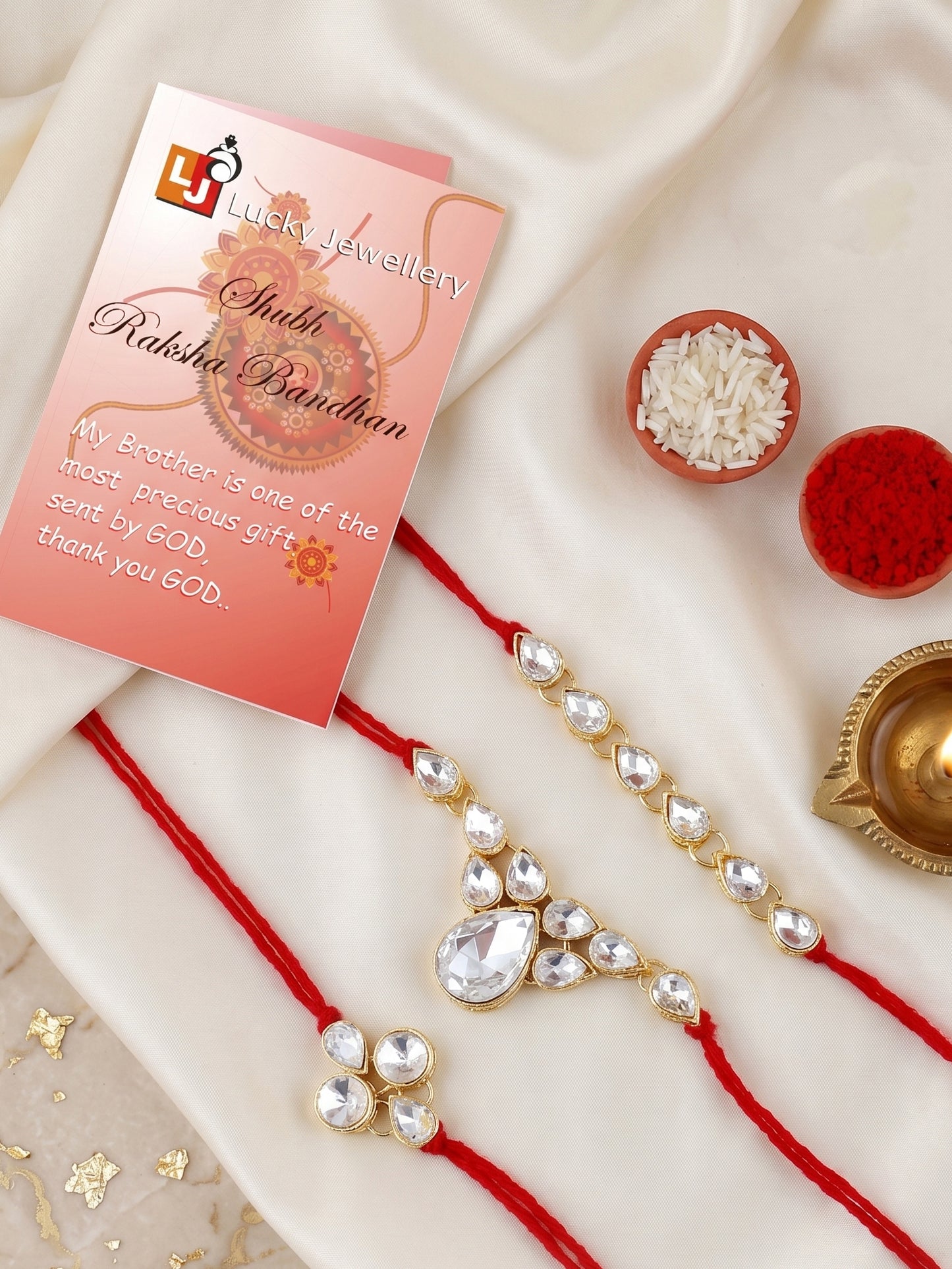 LUCKY JEWELLERY Traditional Rakhi for Brother/Bhaiya – Gold Plated Red Thread Rakshabandhan Rakhie White Stones for Bhai/Bhabhi (Pack of 3) – Fancy Rakhee Bracelet Rakshasutra (159-L1R1-04-W-3-2026)