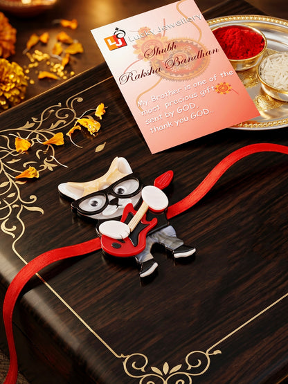 Kids Rakhi: Cute Rockstar Cat Playing Guitar Acrylic Charm on Red Ribbon, Roli, Chawal & Card (440-CHR1-1192-1-2026)
