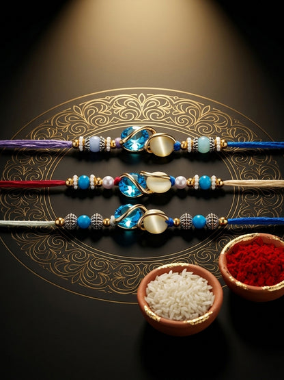 Designer Rakhi Set of 3: Blue Crystal, Cream Stone, Metallic Spacers, Roli, Chawal & Card (300-CHR1-1002A-3-2026)