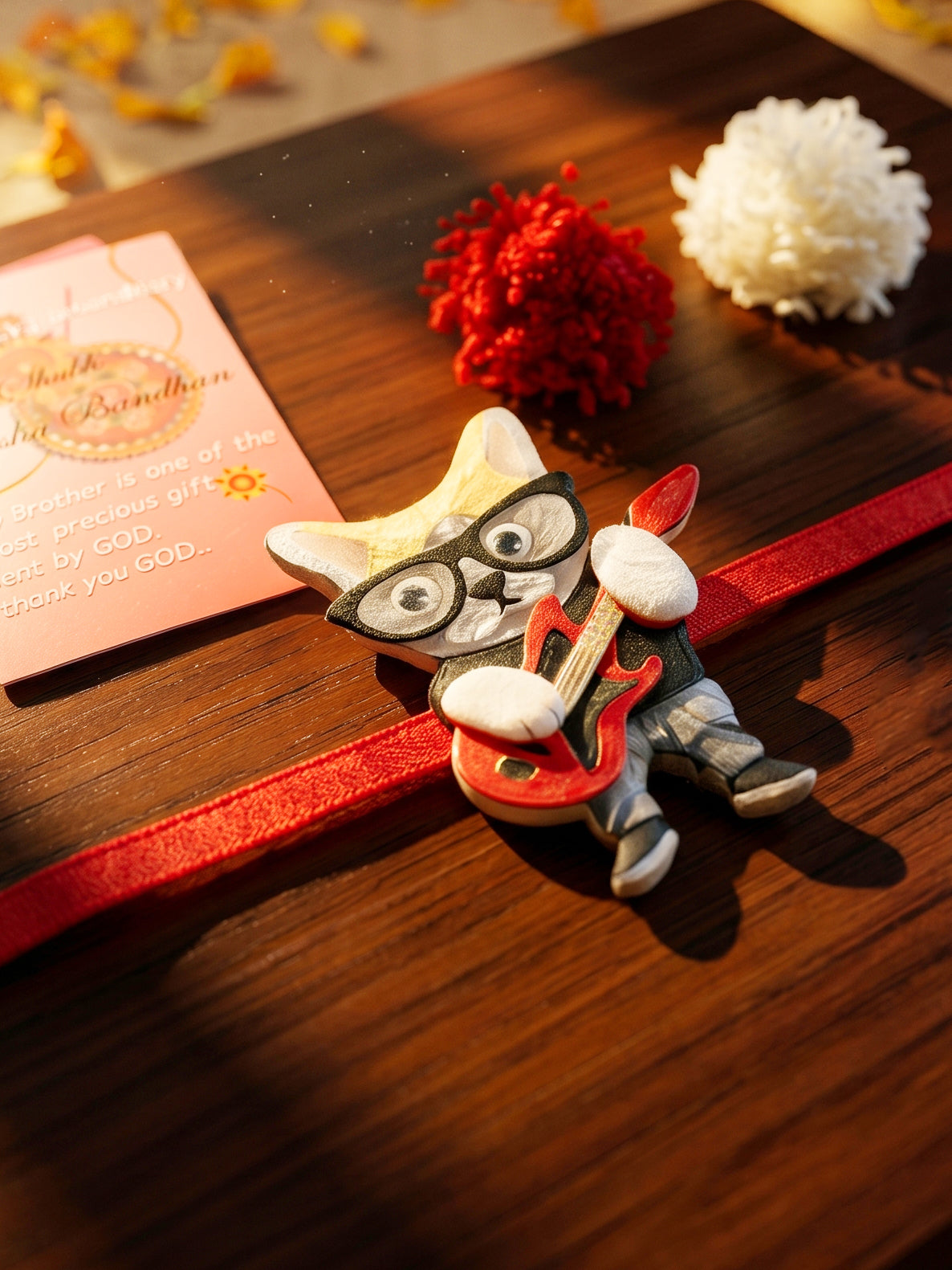 Kids Rakhi: Cute Rockstar Cat Playing Guitar Acrylic Charm on Red Ribbon, Roli, Chawal & Card (440-CHR1-1192-1-2026)