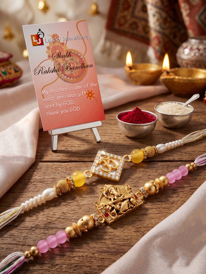 Lucky Jewellery Set of 2 Rakhi with Om & Ganesha Pendants, Pink & Smooth White Beads, Roli Chawal & Card (188-S7R1-2316-2)