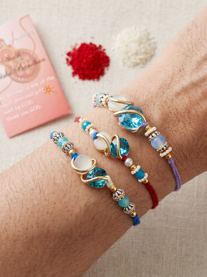 Designer Rakhi Set of 3: Blue Crystal, Cream Stone, Metallic Spacers, Roli, Chawal & Card (300-CHR1-1002A-3-2026)
